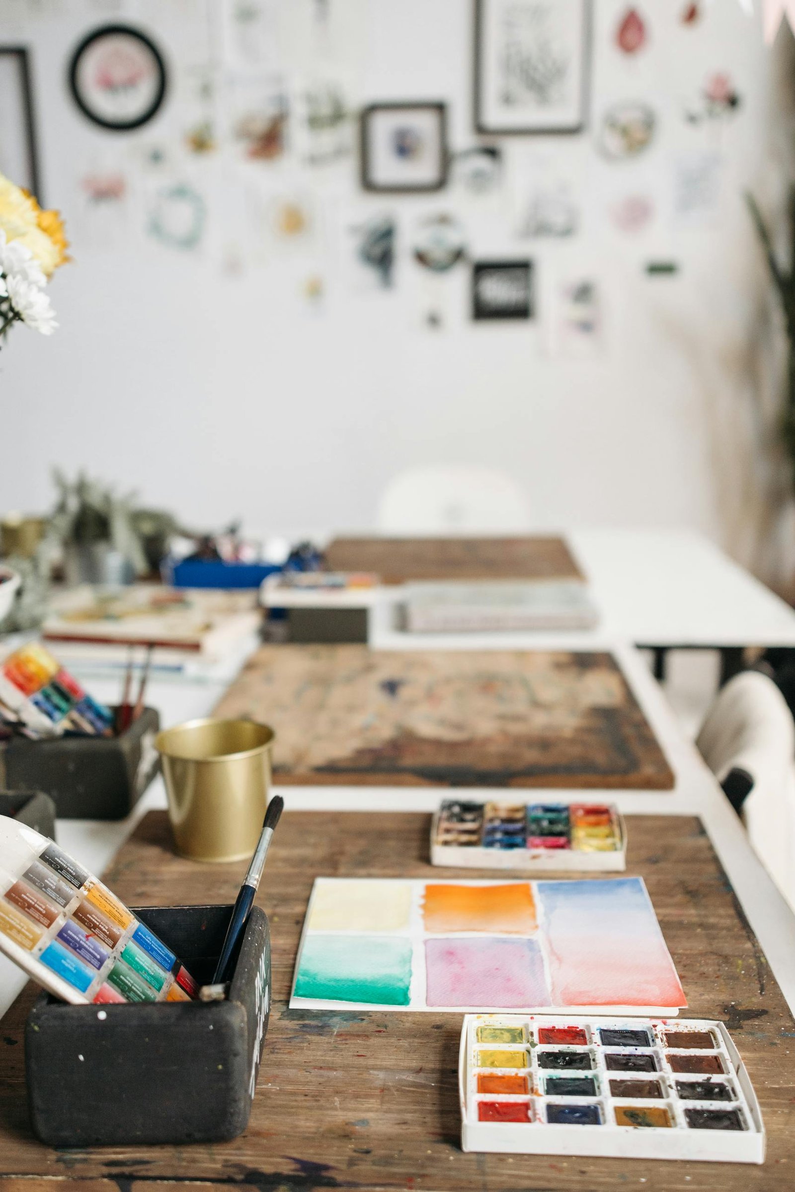 Inspiring art studio with watercolor paints and brushes ready for creative exploration.